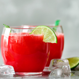 Glass of fresh watermelon juice with lime, mint, ice