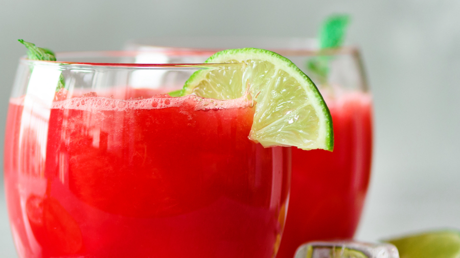 Glass of fresh watermelon juice with lime, mint, ice