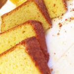 Slice of lemon yogurt cake with lemon glaze on a white plate